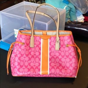Pink and orange coach purse